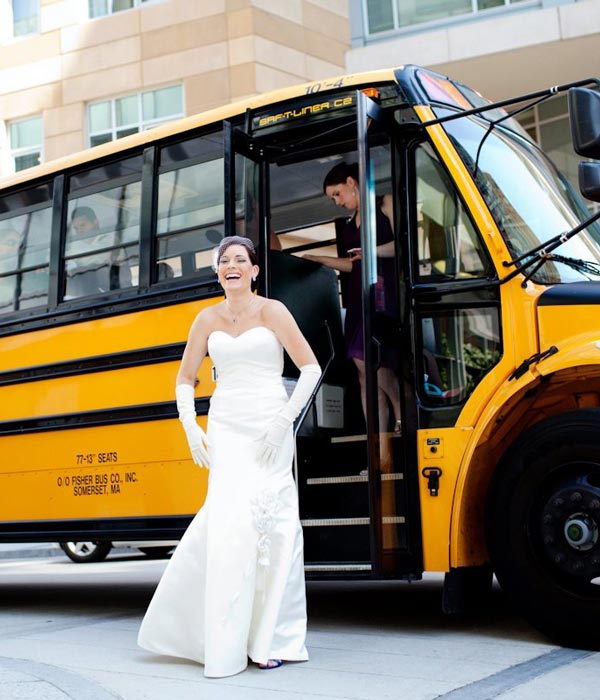 bride standing in front of bus doors