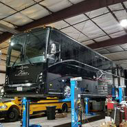 large charter bus getting serviced