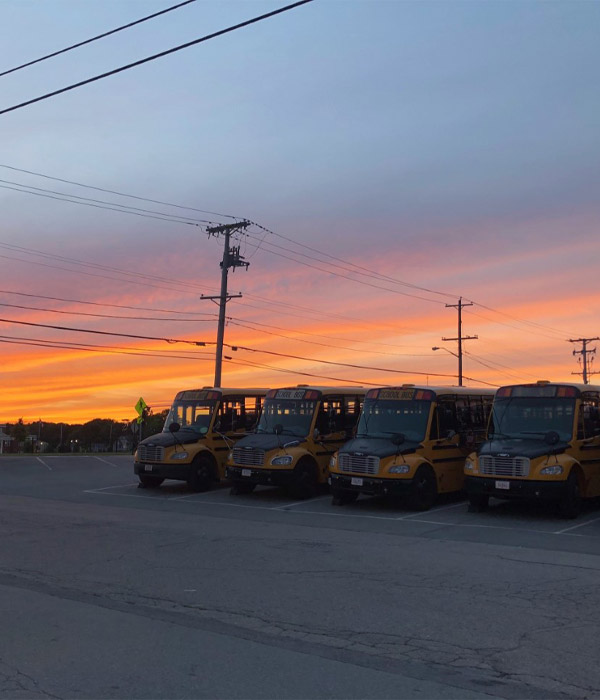 buses parked with beautiful sunset in the background