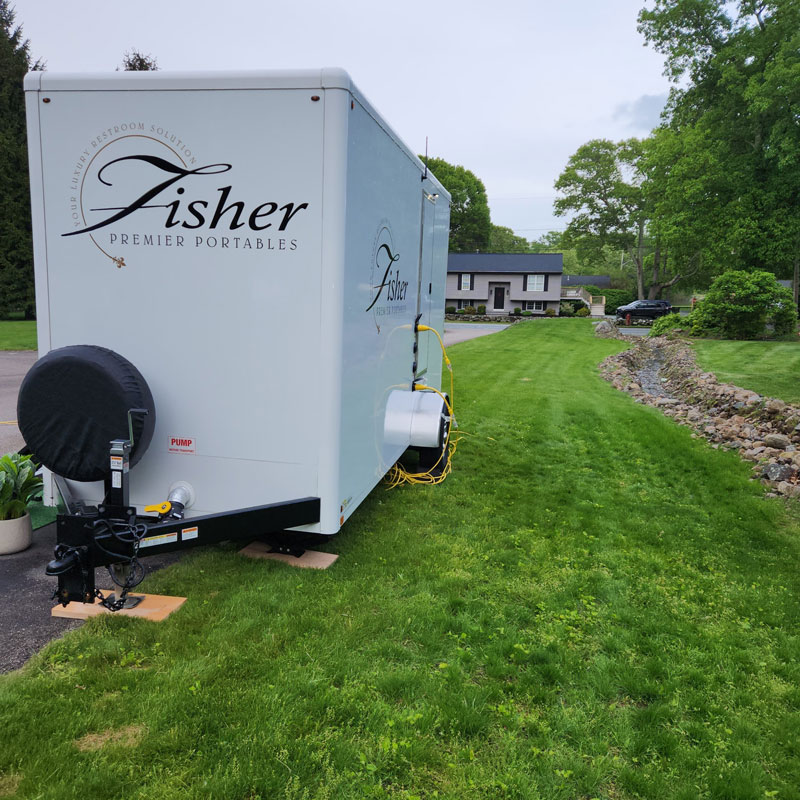 exterior of portable restroom by Fisher Bus Inc.