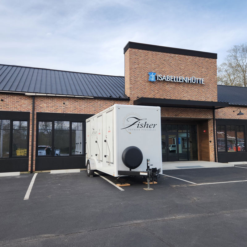 exterior of portable restroom by Fisher Bus Inc.
