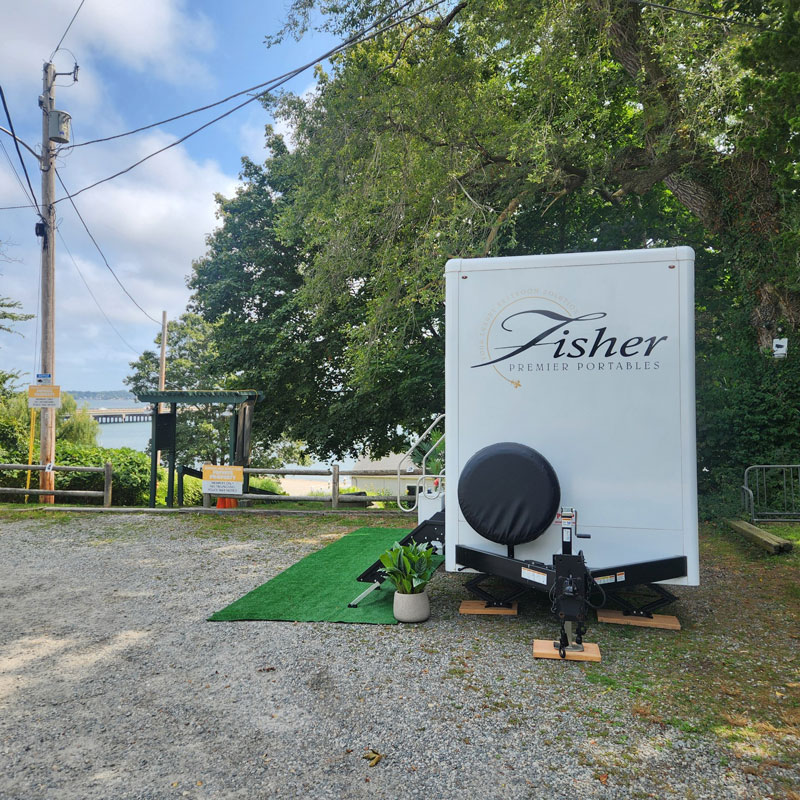exterior of portable restroom by Fisher Bus Inc.