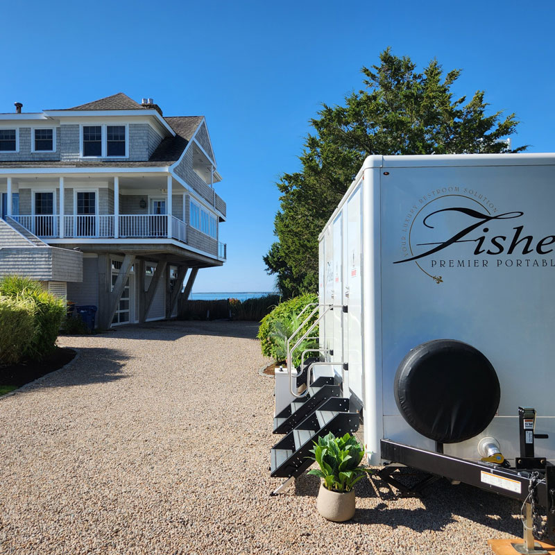 exterior of portable restroom by Fisher Bus Inc.