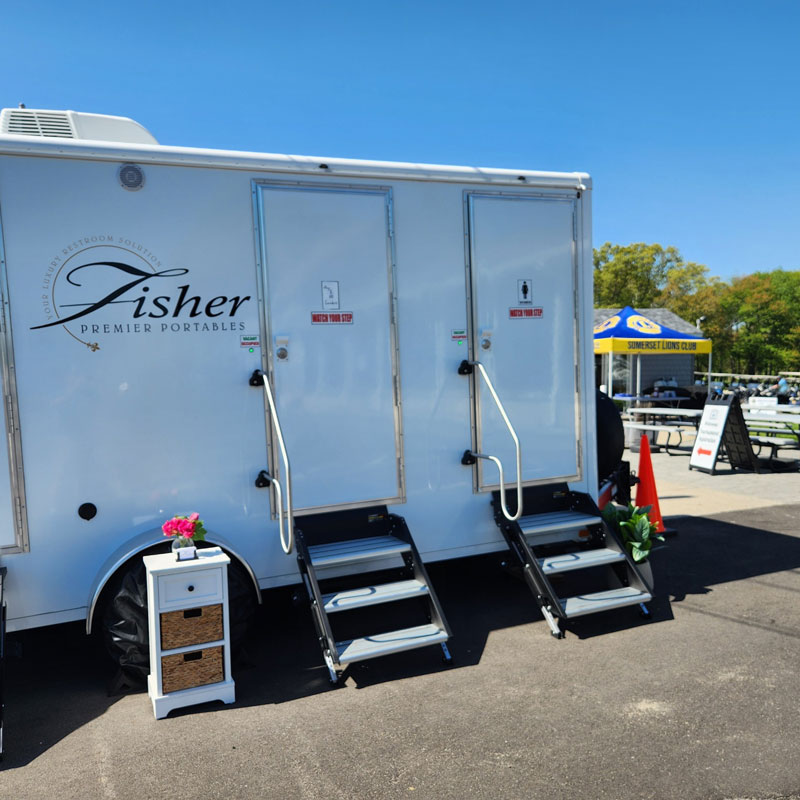 exterior of portable restroom by Fisher Bus Inc.