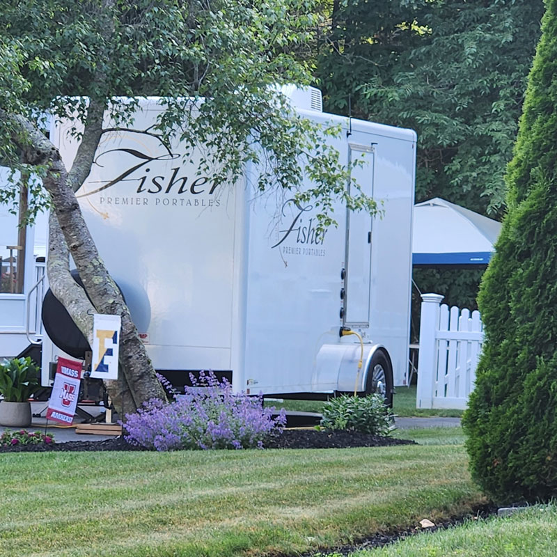 exterior of portable restroom by Fisher Bus Inc.